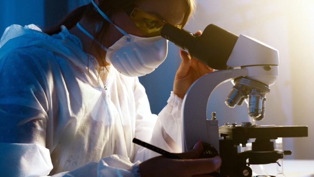 An image of a clinical scientist with a microscope