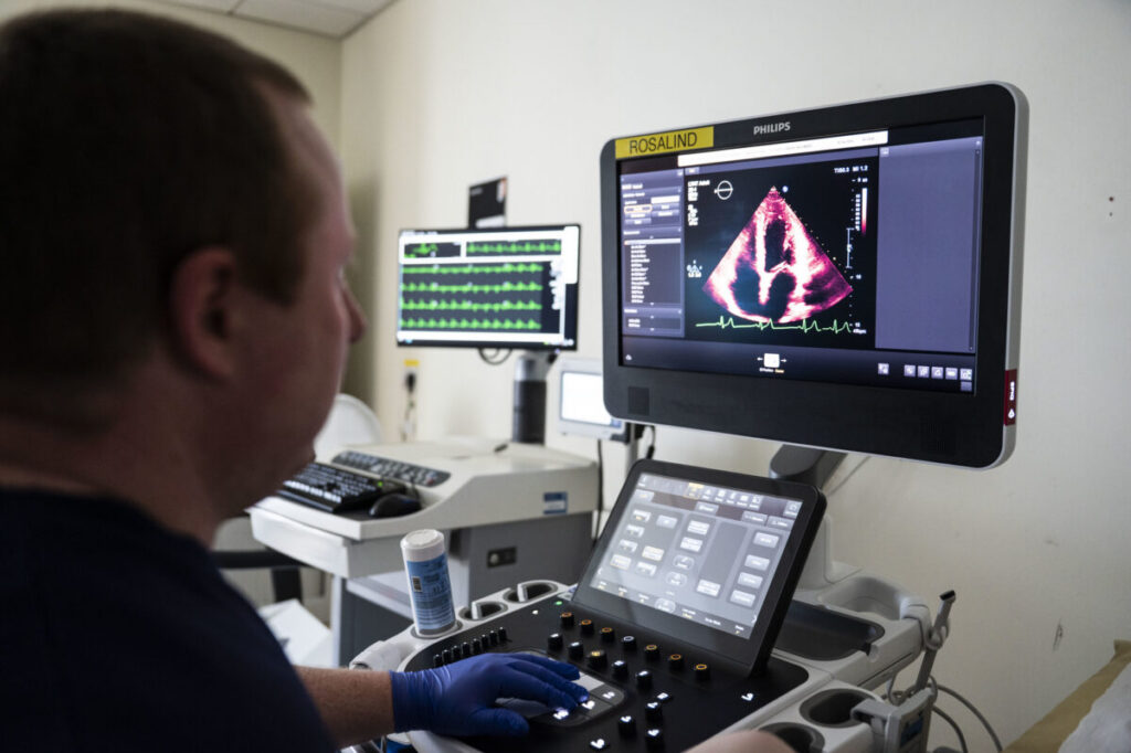 A member of staff looks at a screen showing a cardiac scan