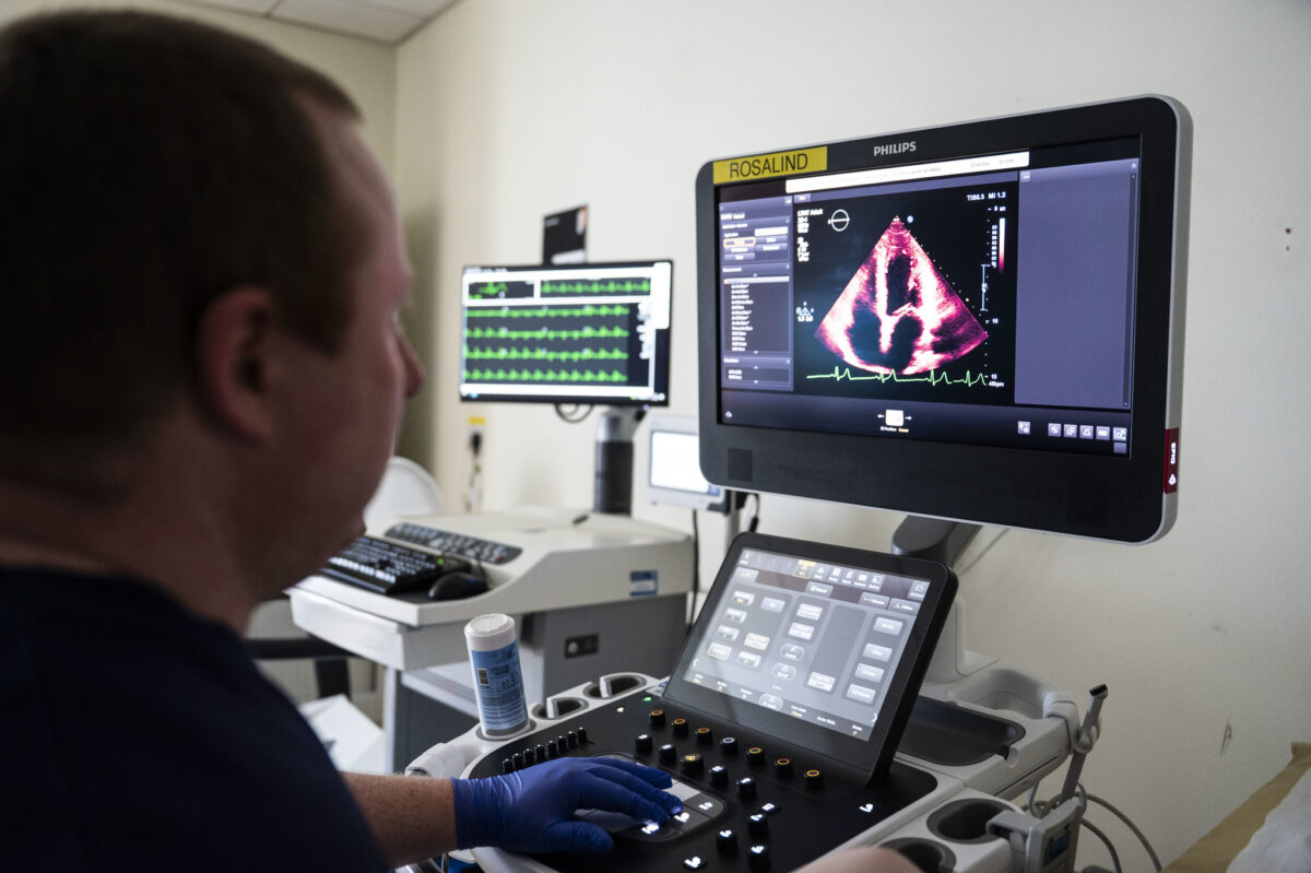A member of staff looks at a screen showing a cardiac scan